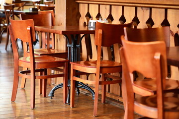 Row of wooden chairs in a modern restaurant setting