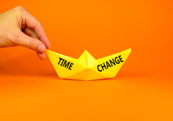Time change symbol. Concept word Time change on beautiful yellow paper boat. Businessman's hand....