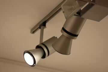 A pair of spotlight lights suspended from the ceiling, ideal for lighting up a stage or setting