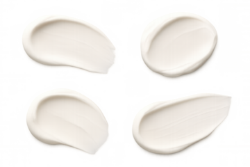 White cosmetic cream smears spreading across transparent surface, highlighting skincare texture