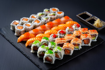 A platter of assorted sushi, sashimi, and maki rolls.