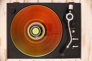 Obraz premium Spinning record, needle arm in natural light. Top view of hi-fi turntable,