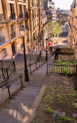 A top view of the iconic cobblestone staircase in Montmartre, Paris, with streetlights and historic...