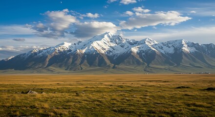 Majestic snow-capped mountains landscape under a blue sky.