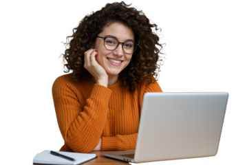 Positive young woman with glasses, smiling and focused while studying or working on her laptop in a comfortable home environment