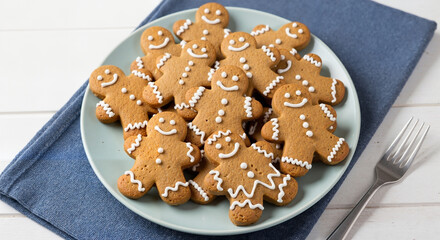 Gingerbread cookies shaped like men arranged on a blue plate  
