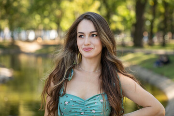 Naklejka premium Full body portrait of a young beautiful woman in a turquoise dress