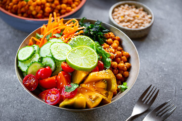 Vegan Buddha Bowl with Chickpeas and Fresh Vegetables, Healthy Eating, Tasty Vegetarian Meal, grey...