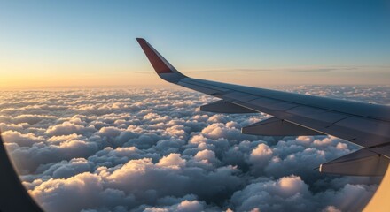 Obraz premium Airplane wing above clouds sunrise view