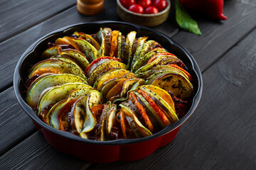 Plate of tasty Ratatouille on dark table close up