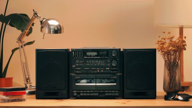 Retro radio tape recorder, audio cassette close-up. Listening to music, old radio boom box player, macro of vintage music listening. 
