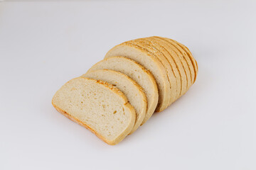 Sliced white bread loaf with sesame on white background, ideal for bakery or food packaging