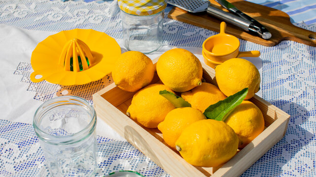 Sunlit lemons bask in rustic wooden crate, embodying aplenty zest vitality, perfect for Lemonade Day and Summer Solstice refreshment