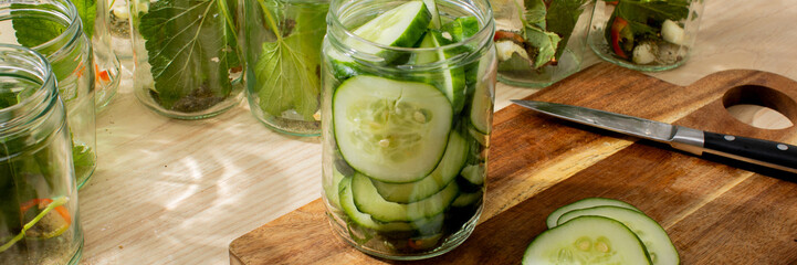 Crisp cucumber slices twirl within mason jars, brewing midsummer dreams of tangy fermentation for...