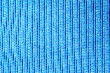 Blue fabric with vertical stripes resembling sweater textile creating soft background for modern...