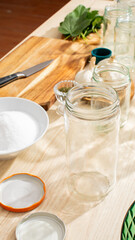 Sunlit pickle jars on rustic table evoke whimsical canning day, celebrating National Pickle Month and the art of fermentation
