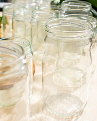 Clear glass jars bask in sunlight, awaiting autumn's apple butter ritual, resonating with Slavic Kupala Night and canning nostalgia