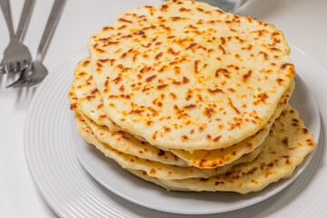 Golden-browned naan stack whispers tales of fragrant Tandoor nights, festival feasting, and the romance of Makar Sankranti