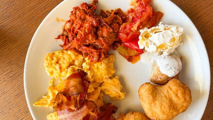 A vibrant breakfast platter dances with scrambled eggs, kimchi, and donuts, celebrating eclectic...