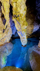 Ethereal stalactites mirror in azure waters, whispering tales of Diwali light festivals and Earth...