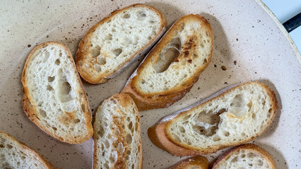 Golden-brown baguette slices resonate rustic charm, ready for Italian aperitivo or cozy autumnal crostini indulgence, ideal for Sourdough September