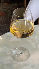 Golden elixir swirls in crystal goblet, evoking Bacchus folly and midsummer revels, ideal for Sommeliers' Day delight