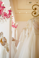 Elegant beautiful white wedding dress on a mannequin in a bridal boutique