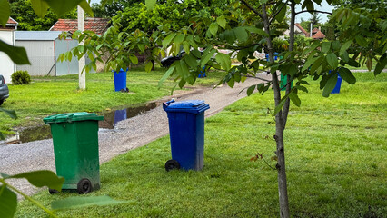 Verdant suburban tableau features whimsical recycling bins, Earth Day, sustainability rituals,...