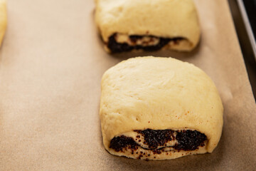 Raw poppy seed buns raw pastry dough baking sweet dessert tasty snack fresh delicious gourmet food background on the table rustic top view copy space