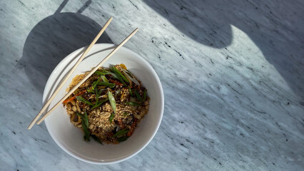 A symphony of sesame aromas dances from sunlit noodle bowl, celebrating Obon festival and World...