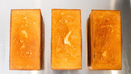 Golden loaves bask under kitchen lights, evoking rustic warmth, reminiscent of Bake Bread Day and...