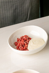 Beef tartare with silky aioli swirls, embodying culinary audacity, World Tapas Day celebration, and Nordic gastronomic delight