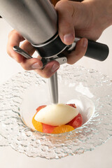 Spectacular culinary alchemy unfolds with creamy delight atop vibrant citrus, echoing Science Day celebrations and avant-garde gourmet artistry