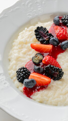 Creamy rice pudding crowned with a symphony of berries, encapsulating the essence of Hygge comfort and Midwinter feast indulgence