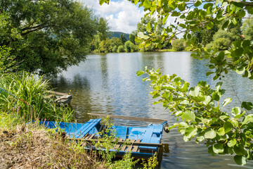 View of a wooden boat parked on a stormy summer day near the Berunka River,Czech