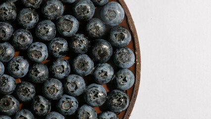 A medley of blueberries on a rustic platter celebrates Nordic Midsummer, evoking echoes of ancient...