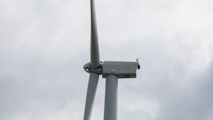 Wind turbine slicing through stormy skies, echoing Earth Day's sustainability and Diwali's symbolic triumph over darkness, renewable whisper