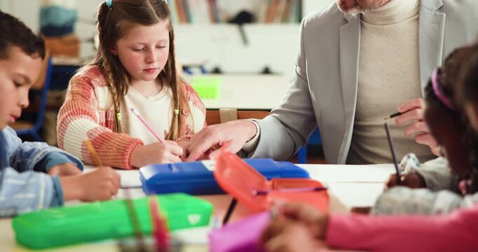 School, teacher and man with students, writing and literature lesson with group, help and education. Teaching, children and knowledge for curriculum, growth and development of kids in elementary
