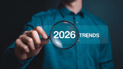 Professional Business Photo with Magnifying Glass Highlighting "2026 TRENDS" on Digital Interface with Dark Teal Background