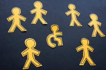 Figures with one in a wheelchair. Inclusivity and accessibility.