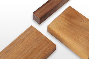 Multiple pieces of wood are joined together, highlighting the contrast in colors and textures of the timber. The sunlight enhances the details of the wood grains and finishes.