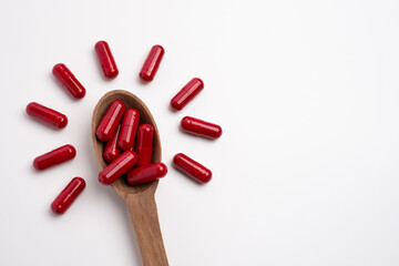Red Capsule Tablet Medicine.Taking vitamins or medications. Concept of healthcare, medicine, pharmacy, disease prevention  
