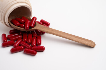 Red Capsule Tablet Medicine.Taking vitamins or medications. Concept of healthcare, medicine, pharmacy, disease prevention  
