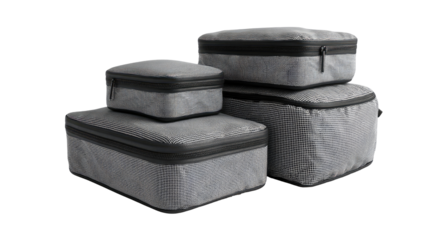 Gray, zippered packing cubes, stacked in a set of four, showing varying sizes