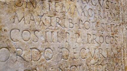 Stadio di Domiziano, Rome, Italy - 10 January 2025. Latin text is deeply engraved on an aged Roman stone, preserving official or commemorative writing from antiquity.