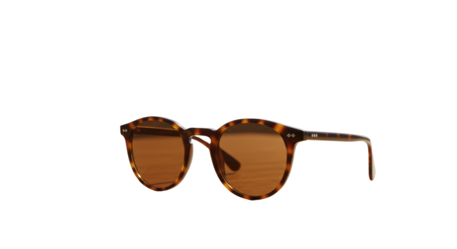 High-quality tortoiseshell round-frame sunglasses with warm brown tinted lenses on smooth light wood, blurred modern outdoor space with creamy bokeh, tranquil luxury product concept