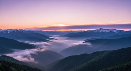 Obraz premium Majestic Mountain Range at Sunset with Fog Filled Valleys and Soft Light Displaying Natural Beauty