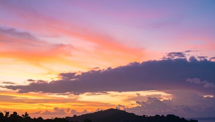 Striking tropical sunset casts vibrant hues across the horizon sky