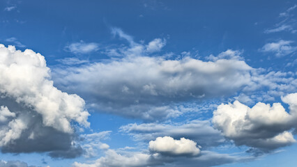White cumulus clouds against a blue sky