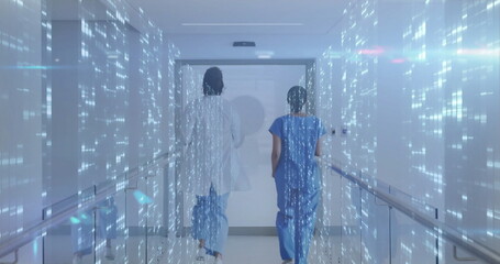 Two staff in scrubs and coat walking toward door in hospital corridor with holographic data streams